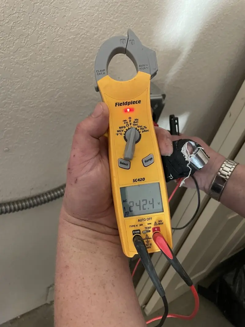 Voltage testing with clamp meter during Ceiling Fan Installation in Newport